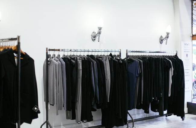 Clothes hanging on racks.