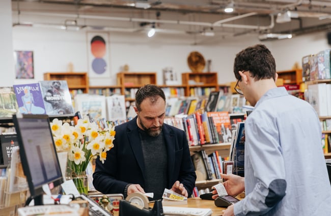 A man buying a book.