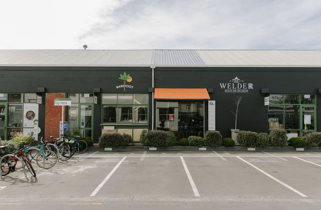 The black exterior of The Welder Christchurch with green framing.