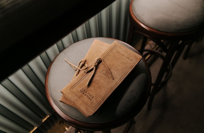 Leather-covered drinks menu on a stool at Austin Club in Christchurch.