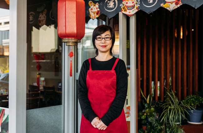 Lei, owner of Dumpling House, stands outside the restaurant.