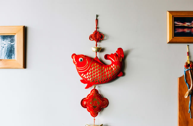Traditional fish decoration hanging on the wall at Dumpling House.