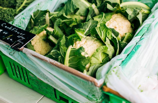 Close up of cauliflower in green bins.