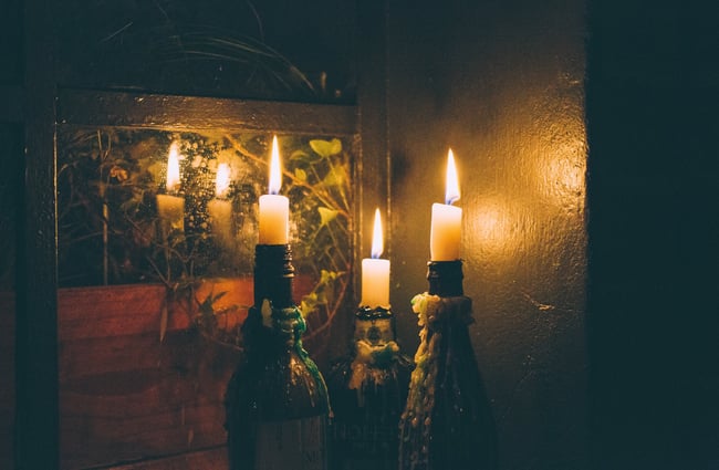 Candles in wine bottles.