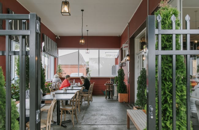 Outdoor, covered dining area at Little Poms café, Christchurch.