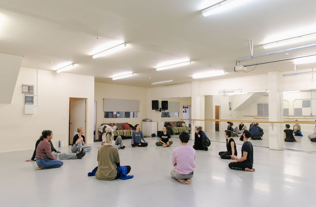 Group of dancers sat in circle before class at Movement Art Practice.