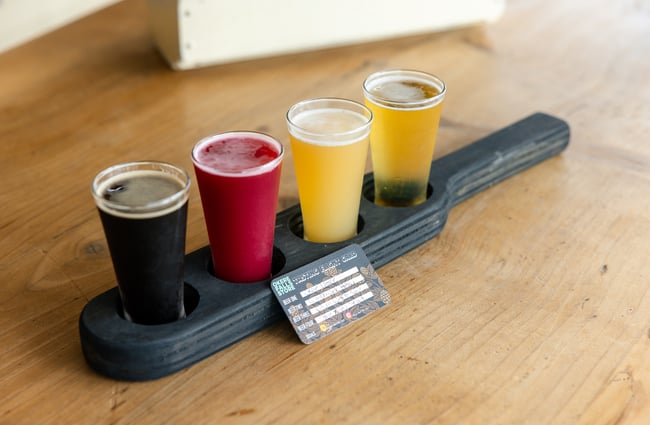 A craft beer tasting flight of four glasses at Okere Falls Store.