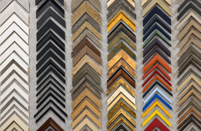 Close up of picture framing corner samples displayed on the wall at Portico.