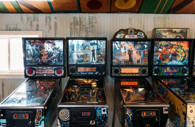 The retro pinball machines against the back wall of Seashore Cabaret.