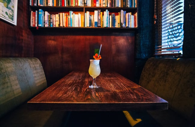 A cocktail on a table inside The Library bar Wellington.