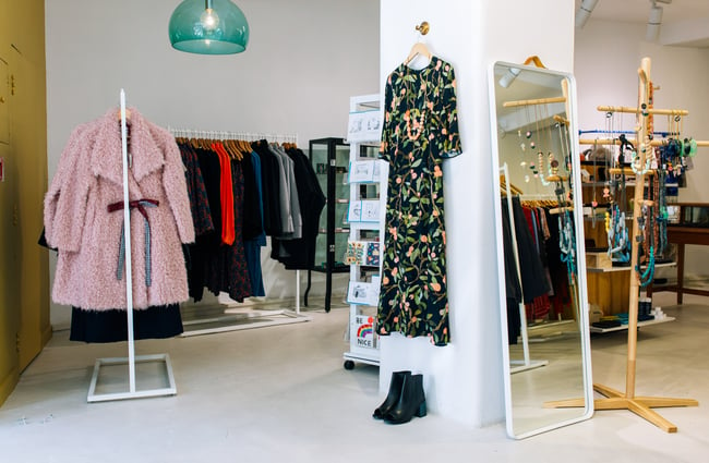 A coat and dress hanging up inside Wanda Harland Wakefield Street store in Wellington, New Zealand.