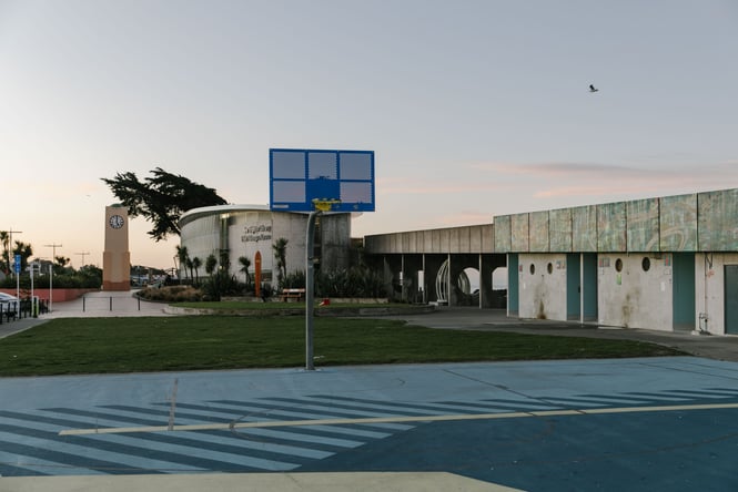 Dark and light blue basketball court next to the beach in Christchurch New Zealand.