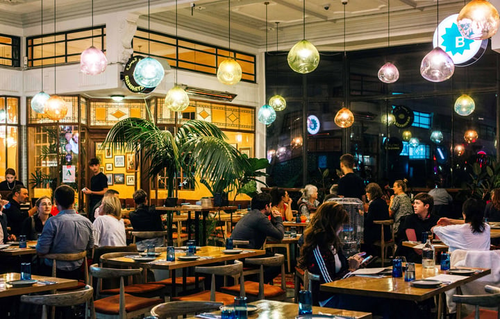 Customers dining under colourful bulbs at Gemmayze Street in Auckland.