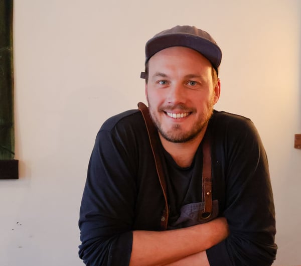 Image of the Chef Alex Davies wearing a cap.