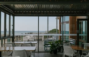 Looking across the indoor dining area and out to the water and beach at Del Mar.