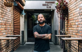 Bobby Brazuka standing in front of his business the Ponsonby Social Club in Auckland.