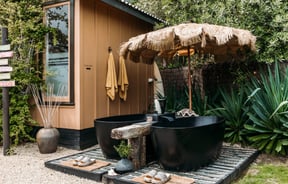 Black bath tubs and a small hut.