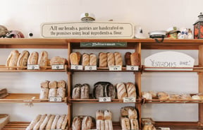 Fresh bread lined up on bakery shelves at Deja Moo & Harbour Street Bakery in Ōamaru.