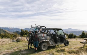 Lifting mountain bikes off a cart.