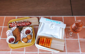 Bird eye view image of a tray of food from Swings on a tiled surface.