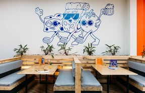 A blue illustration on a wall inside Tony's Pizza in Palmerston North.