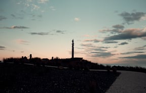 A view of a tall sculpture in Kaikoura at sunset.
