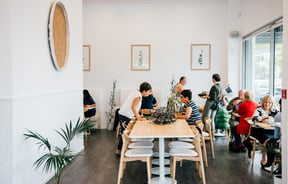 People dining around a table at The Origin, Christchurch.