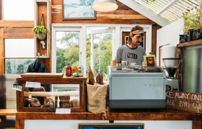 A staff member working behind the counter in the Bacca Bakery cafe.