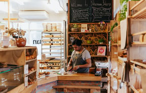 Bakery interior with shelves of breads.