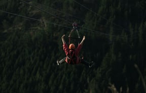 A person flying down one of the zip lines at Christchurch Adventure Park.