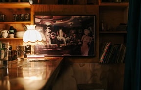 Retro lampshade on the bar with James Dean photo on the wall.