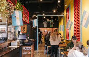 People dining inside El Quincho in Riverside Market.