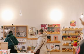 Two woman browsing at Little Beehive Co-op.