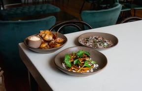 Three dishes of food on a table at Miro in the old Caffe Roma building in Christchurch.