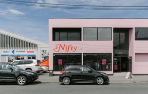 The pink block exterior of Nifty in Christchurch.