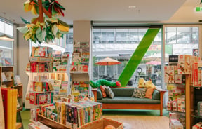 Books on shelves and seating area at Telling Tales, Christchurch.