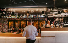 Man ordering a beer at the bar at Craft Embassy.