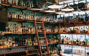 All the liquor bottles on display on shelves.