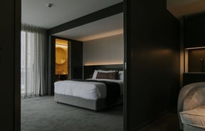 A dark grey and white bedroom inside The Mayfair Christchurch.