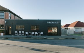 The painted black brick exterior of Triangle Espresso in Ashburton.