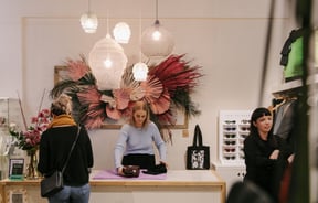 Woman serving a customer at the counter at Trouble and Fox.