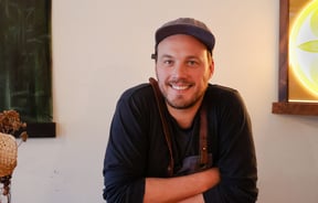 Image of the Chef Alex Davies wearing a cap.