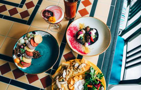 Mexican meals on colourful plates.