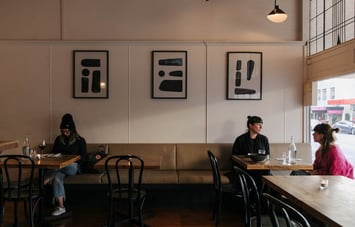 Customers sitting on a bench seat at Arden.