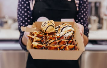 Waffle with scoop of gelato on top.