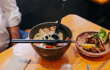 Bowl of fresh ramen with sides.