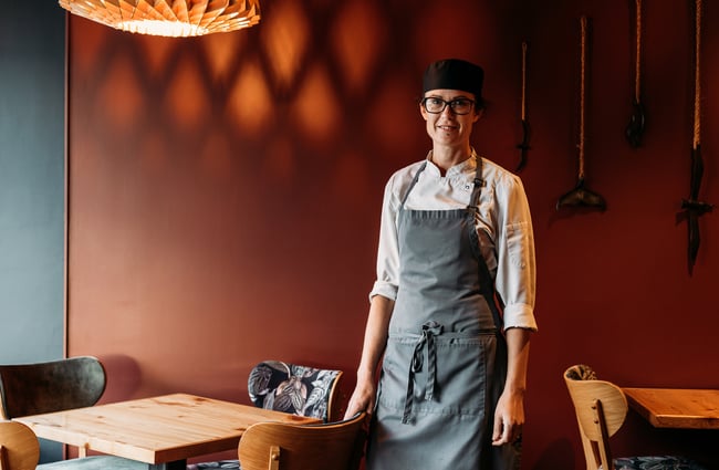 A female chef posing for camera.