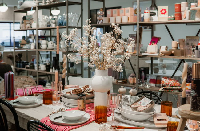 A decorative table setting inside a large retail store.