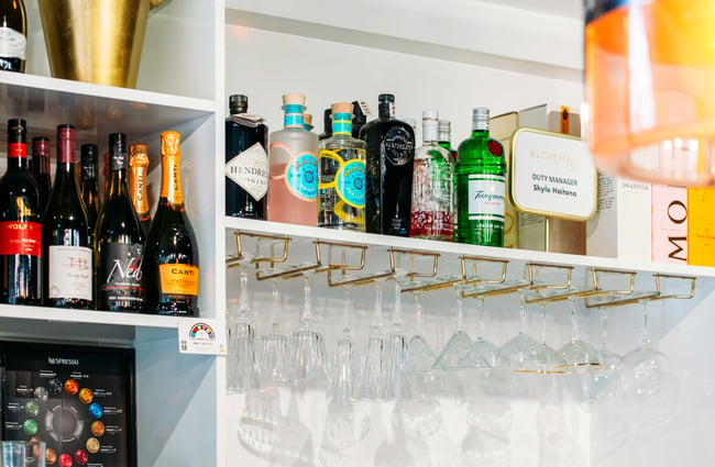Close up of liquor spirits bottles on a shelf.