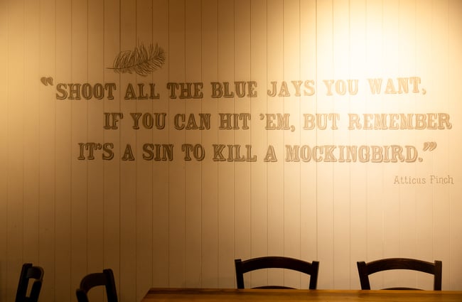 A large quote from To Kill a Mockingbird adorns a wall inside Atticus Finch.